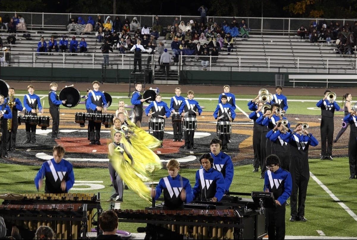 Drumline, brass and color guard members perform during the Marching Blue Devils’ 2026 show.