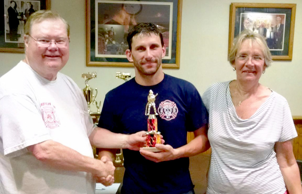 Dunellen Fire Dept's Rich Freyer is presented with the 4th place trophy by race chairman and former Dunellen firefighter Frank Reilly and Burn Center Foundation director Kathy Conlon.