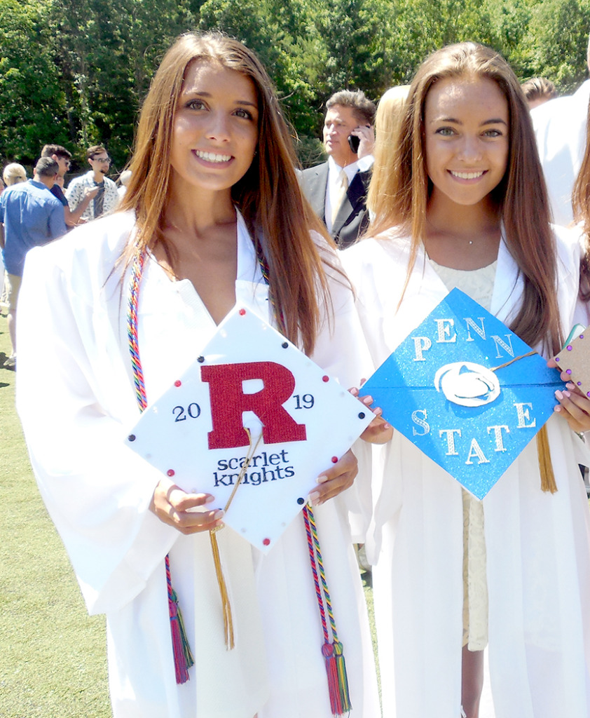 Many graduating seniors at the Watchung Hills Regional High School graduation on June 24 decorated their caps with indications of where they plan to attend college. From left are, Jacky Mentone of Millington, who plans to attend Rutgers University, Gabby Salazar of Green Brook Township who plans to attend Penn State University.
