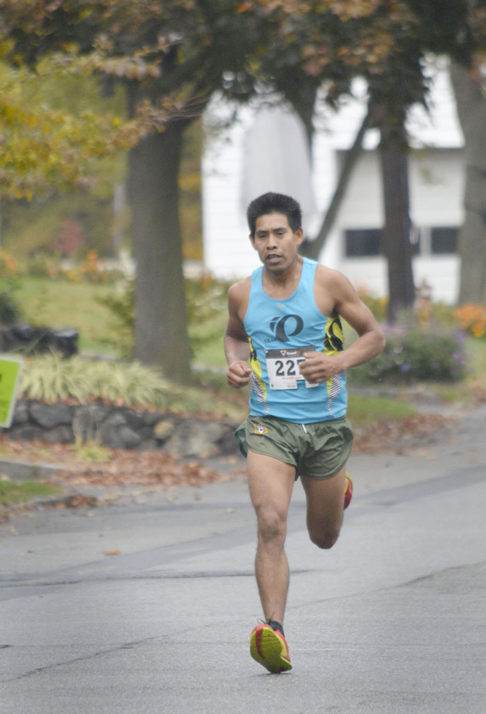 With two miles to go, Rusino Medenz of Metuchen, N.J., has a wide lead in the Fanwood 5K in Fanwood, NJ, Sunday, Oct. 25, 2015. Medenz won, finishing the race in 17.44 minutes, more than a minute ahead of the second-place finisher. (Photo by Brian Horton)