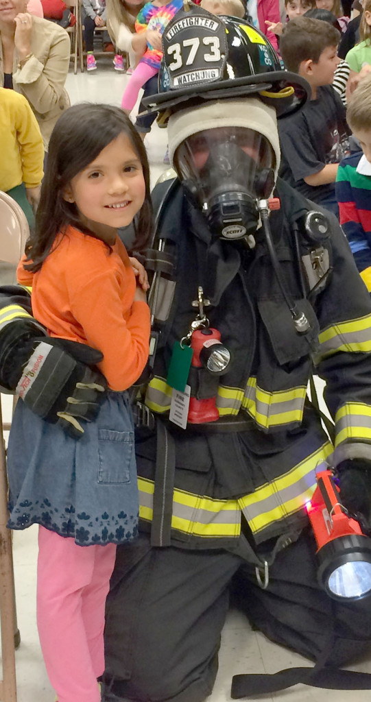 (above) First grade student, Emma Speeney, meets up with her uncle, who is a Watchung volunteer firefighter.