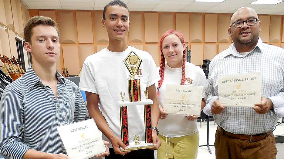 The Watchung Hills Regional High School Marching Warriors Band won first place in their class of schools, and fourth place overall, at the U.S. Bands-sponsored band competition held on Saturday, Sept. 12, at Edison High School, Edison Township. From left are: Senior Tuba player John Ray of Warren Township, who is also the band’s Brass Captain; Sophomore Tuba player Ethan Marmolejos of Watchung; Junior Clarinet player Amelia Stepperfenne of Millington; and new Band Director Minesh Shah. The Marching Warriors Band can be seen performing at all home football games, and their program this year is organized under the theme, “A Night with Netflix,” and features music from the movies, “Captain America,” “The Lion King” and “Slumdog Millionaire.”