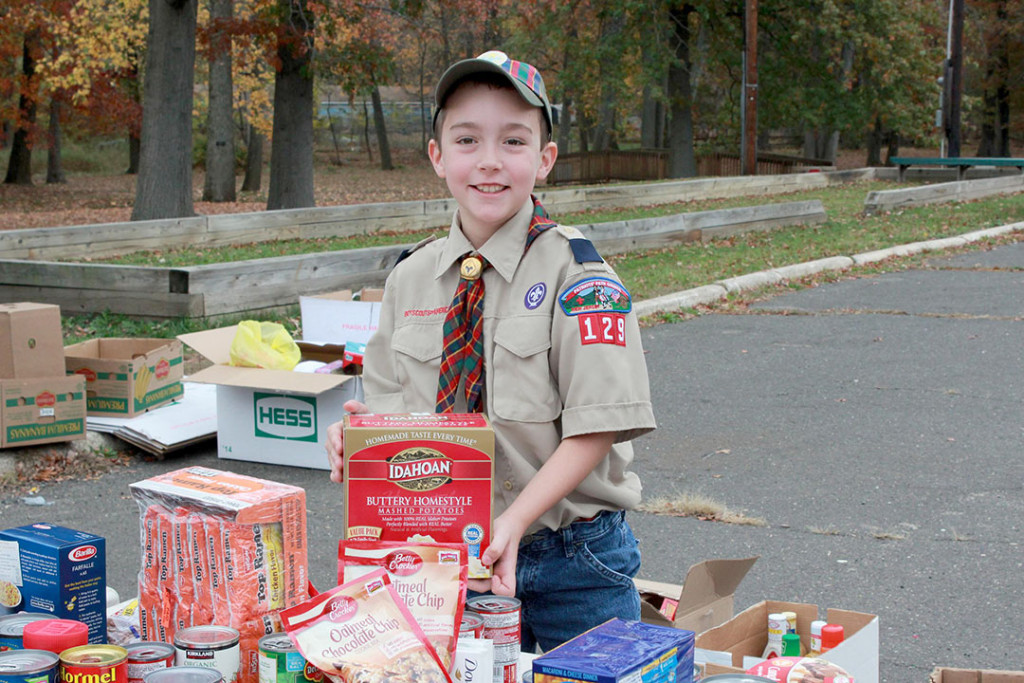 (above) Cub Scout David Schreck drops off donated food for those in need.