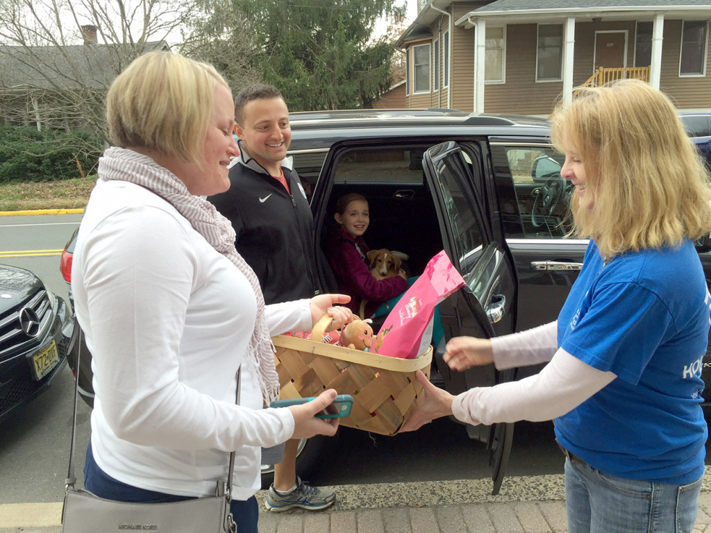 (above) A longtime volunteer gives the Perrone family a special gift basket as they prepare to take Stella home as thanks for opting to adopt.