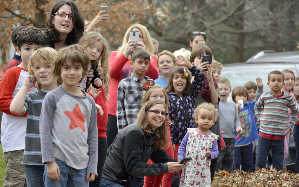 (above) Kids and adults alike watch as Santa pulls on to their street during the Fanwood Fire Department’s "Santa run".