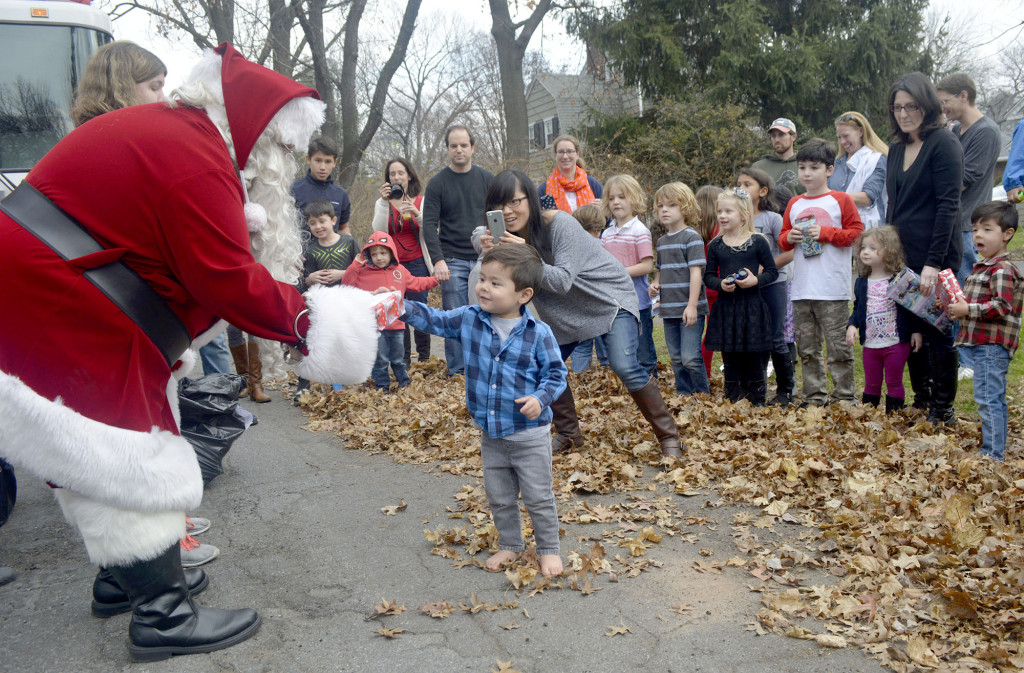 (above) A youngster comes forward to get his gift from Santa as others wait during the Fanwood Fire Dept.'s "Santa run".