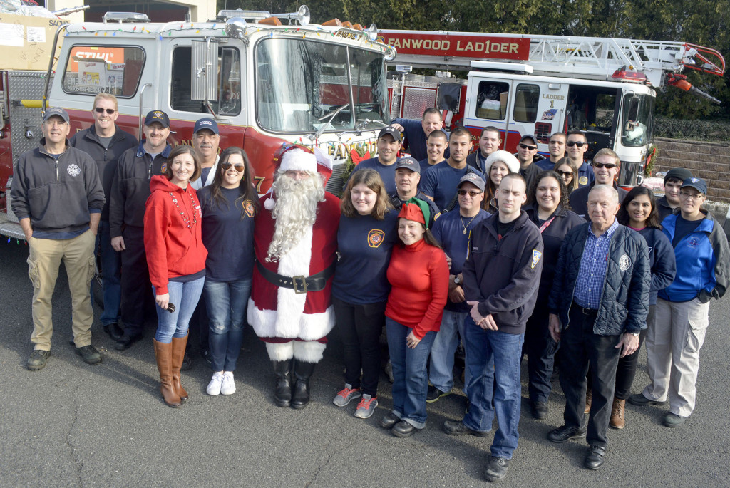 (above) Volunteers from the Fanwood Fire Department and Fanwood Rescue Squad with Santa before starting out on the annual "Santa run".