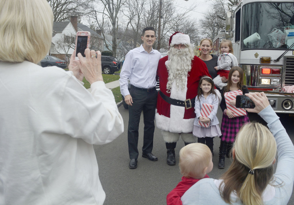 (above) Santa is the center of attention while delivering gifts on the Fanwood Fire Department’s "Santa Run".