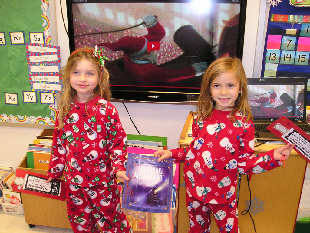 (above) Westfield Kindergartners Melanie Johannsen (at left) and Hayden Bridge, in snowmen adorned pj’s, displayed their Polar Express entry tickets and memory book at Lincoln School’s festive event held on December 18.