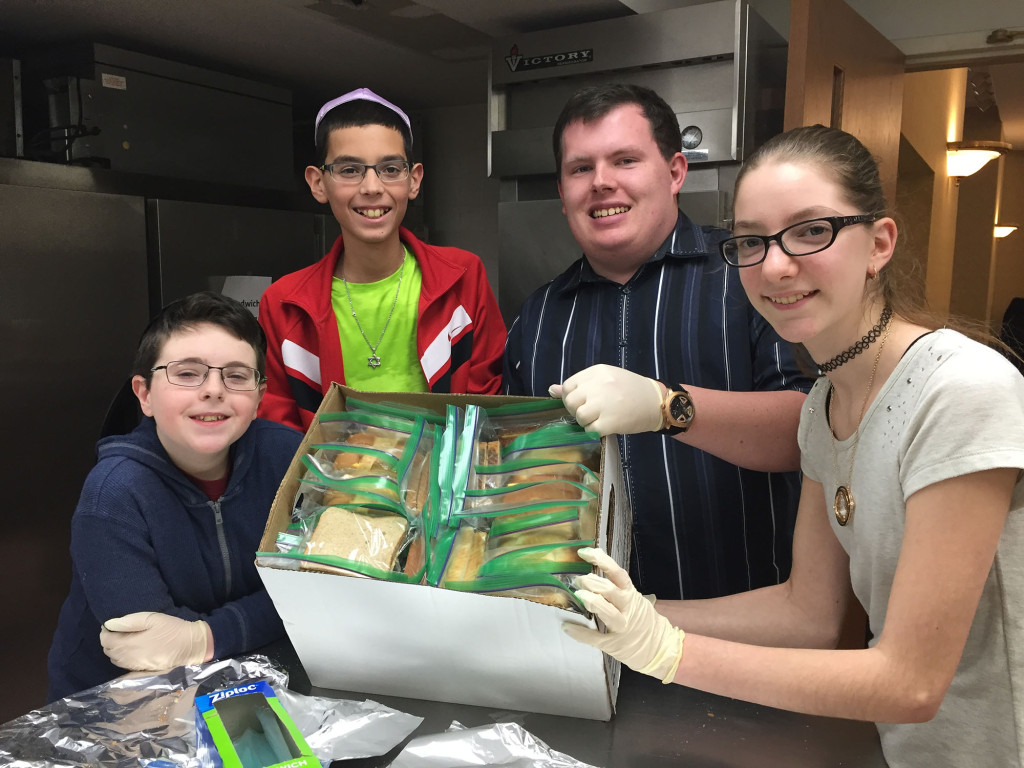 (above l-r): Josh Friedson; Matt Sabony; Ross Bernstein, Congregation Beth Israel’s Kadima advisor; and Samantha Bates in the kitchen of Beth Israel.