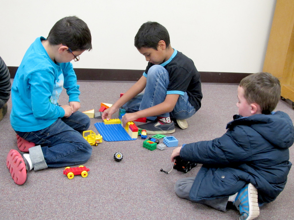 (above) Uriel Palacios, age 10, Anthony Palacios, age 8, and Campbell Maloney, age 5, of North Plainfield construct a Minecraft building in real life at a Minecraft Party on November 14, 2015.