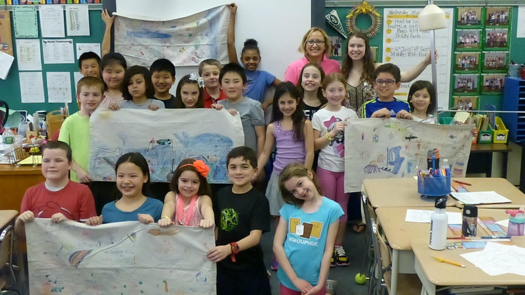 (above) Students holding up their decorated fins as part of lesson.