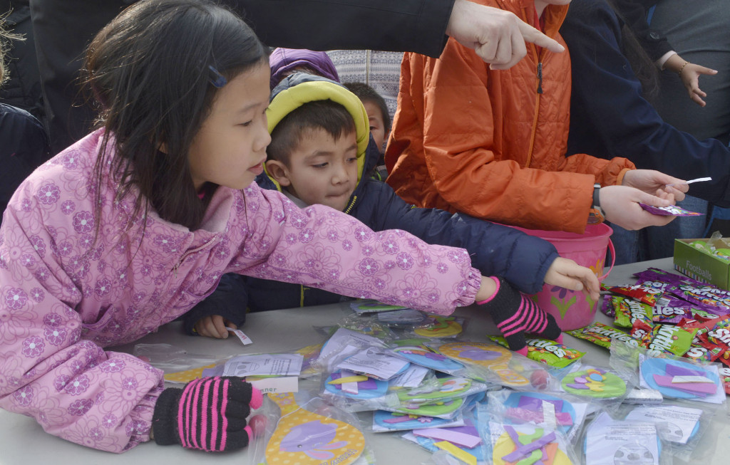 (above) Kids reach for the prizes at the annual Easter Egg Hunt.