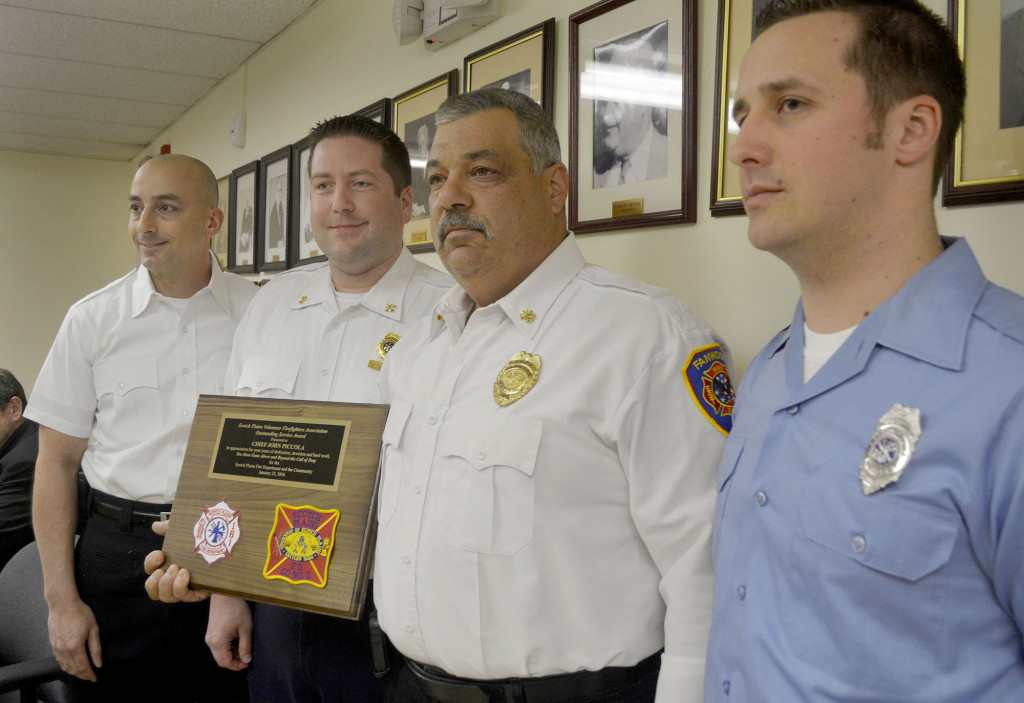 (above) Fanwood Fire Dept. Chief John Piccola, second from right, was honored by the Scotch Plains Volunteer Firefighters Association with the group's 2015 outstanding service award at a the March 21, 2016 Fanwood council meeting. With Piccola are Scotch Plains Fire Dept. Capt. Joe Rodrigues, left, Battalion Chief Skip Paal, second from left, and Captain Dennis Hercel, right, who made the presentation. Piccola was honored for his many years of leadership and fostering of cooperation between the Fanwood and Scotch Plains departments.