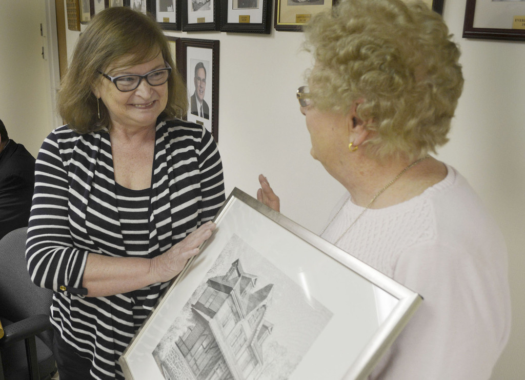 Ellen Morris, left, accepts a framed print of Fanwood's historic north side train station from Council President Kathy Mitchell after being named as the borough's volunteer of the month at a borough council meeting in Fanwood, NJ, Monday, March 21, 2016. Morris is the longtime leader of the group that oversees and maintains the many floral planters in the borough's downtown area. (Photo by Brian Horton)