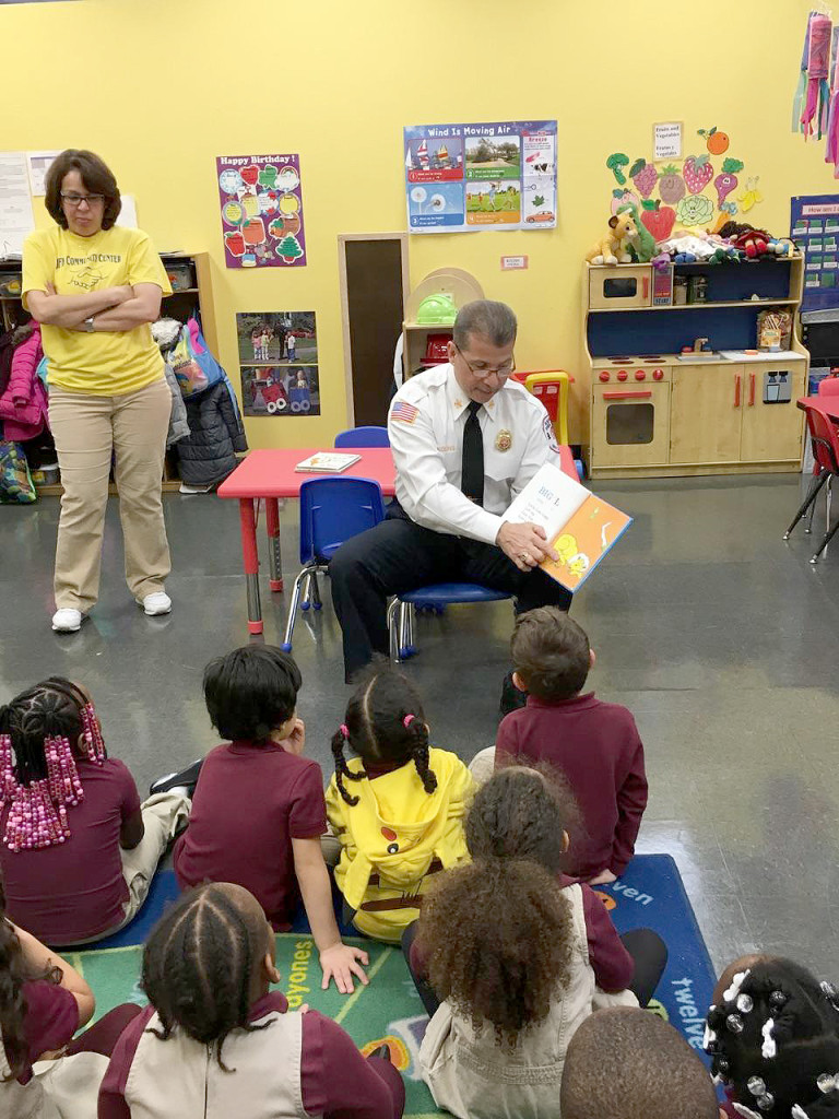 (above, l-r) Chief William R. Young Jr. of the Rahway Fire Department is shown on March 16, 2016 reading Dr. Seuss to the children of Ms. Jane’s and Mrs. Virginia’s Pre-Kindergarten class at The Rahway JFK Center.