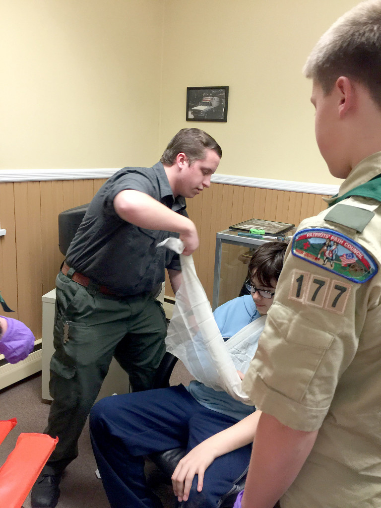 (above) EMT Saverio Zipeto demonstrating on a troop member.