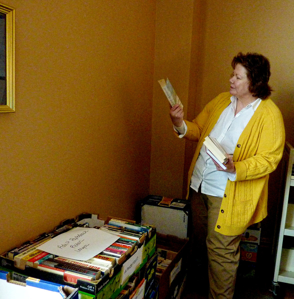 (above) Friend of the library member Helen Mederos sorts incoming books for the April book sale.