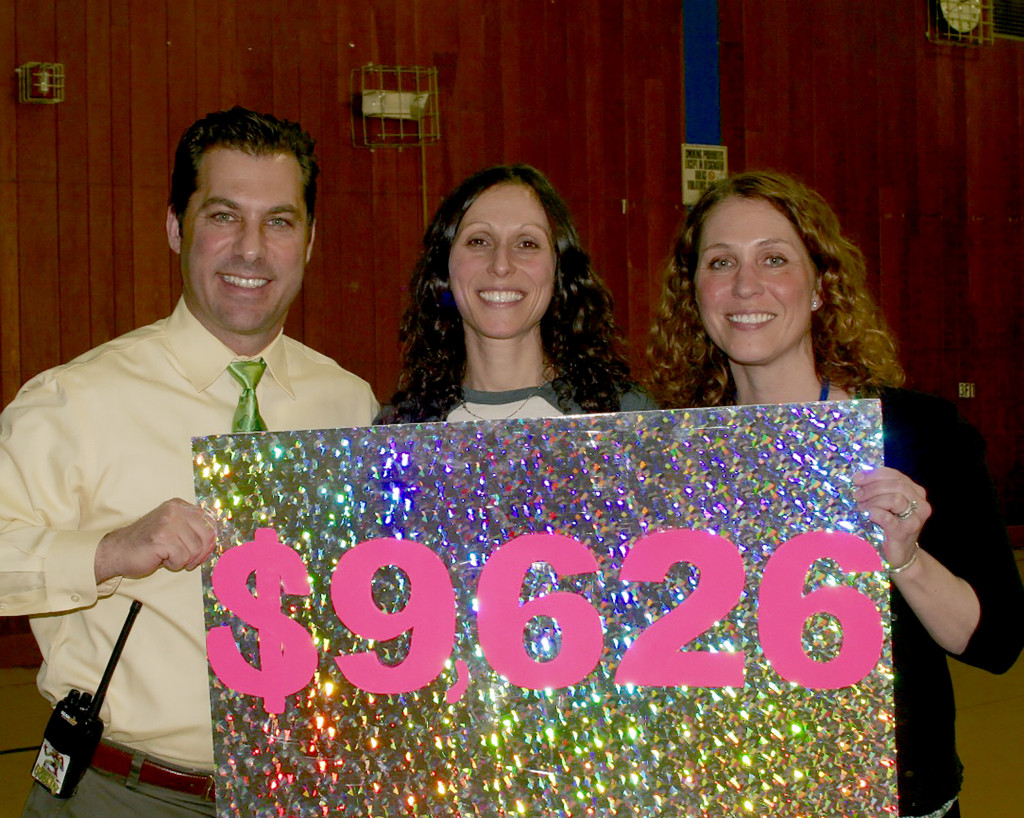 (above) Tamaques Principal David Duelks, cochair parent volunteer Jennifer Carbone and Christine Pitarresi, Tamaques Librarian, proudly display the record-breaking fundraising total for the elementary school's 2016 Reading Marathon.