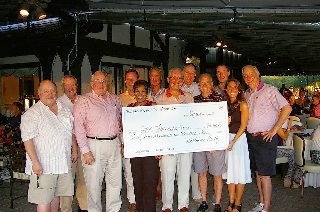 (above) The Sean Reilly TBI Fund Board of Directors proudly displays it’s check for over $64,000 to The JFK Foundation