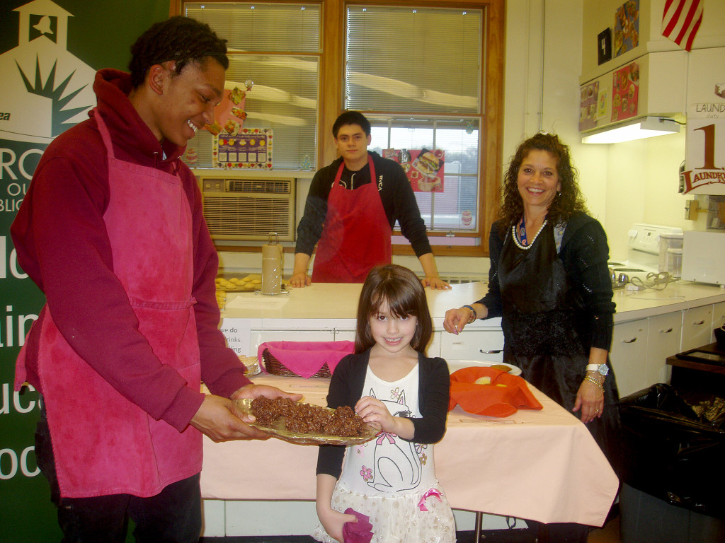 (above) West End School Kindergartener Marissa Yannetta was invited to the Arts Festival, since her artwork, “Bugs” was on display. There she visited the fresh baked area and met North Plainfield High School Juniors Kam Slaughter and Andy Amaya and NPHS Family and Consumer Science Teacher Clare McEnroe.