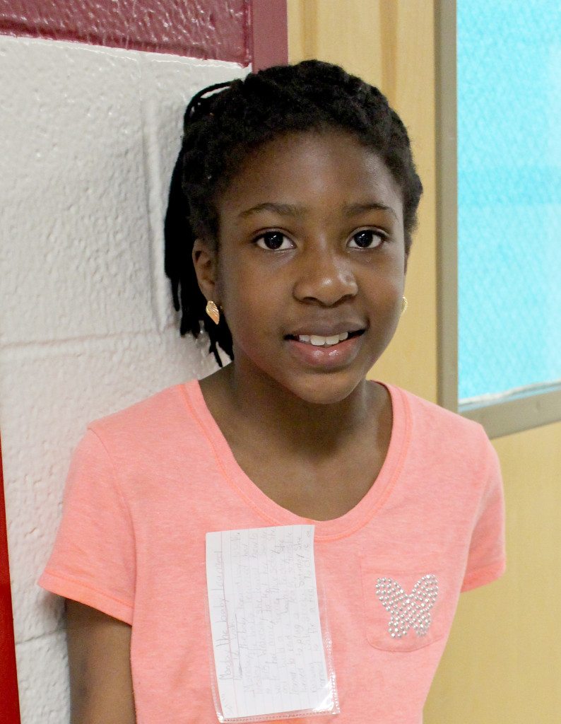 (above) Selita Ikejibeh displays her pocket poem on April 21, National Poem in Your Pocket Day.