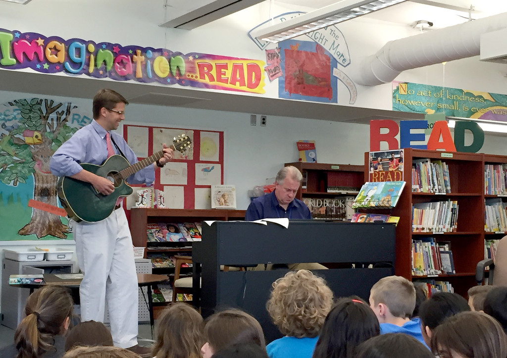 (above) Principal Scott Cook demonstrates the connection between poetry and songwriting.