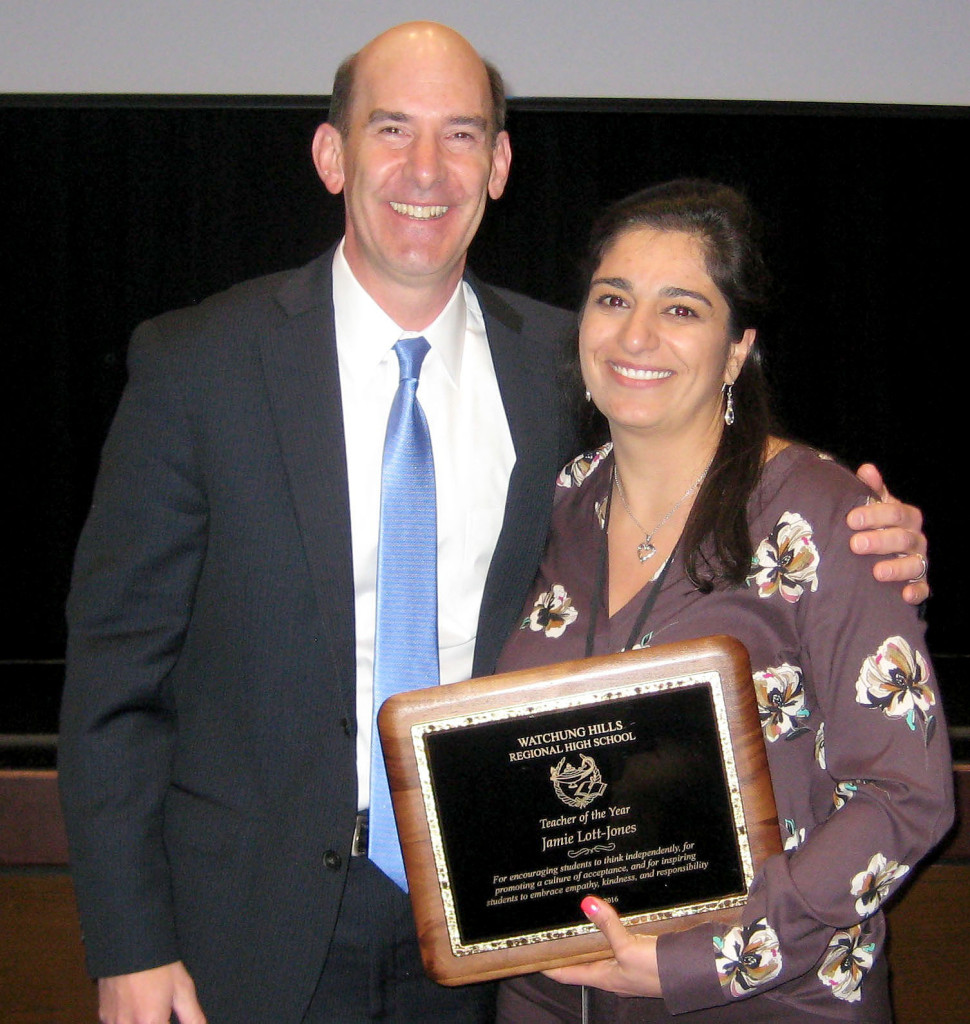 (above) Watchung Hills Regional High School (WHRHS) Principal George Alexis presents the 2016 Teacher of the Year plaque to 18-year WHRHS History Teacher Jamie Lott-Jones.