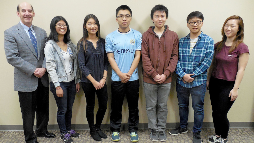 (above) Watchung Hills Regional High School (WHRHS) Principal George Alexis, left, congratulates the six WHRHS students named National Merit Finalists, and two students nominated as U.S. Presidential Scholars. The National Merit Finalists are, from left, Isis M. Zhang of Stirling, and Claire Yuxuan Chen, Henry Zhu, Eric Zhu, Kunwoo Park, and Emily K. Kim, all of Warren Township. Zhang and Chen are also nominated as U.S. Presidential Scholars.