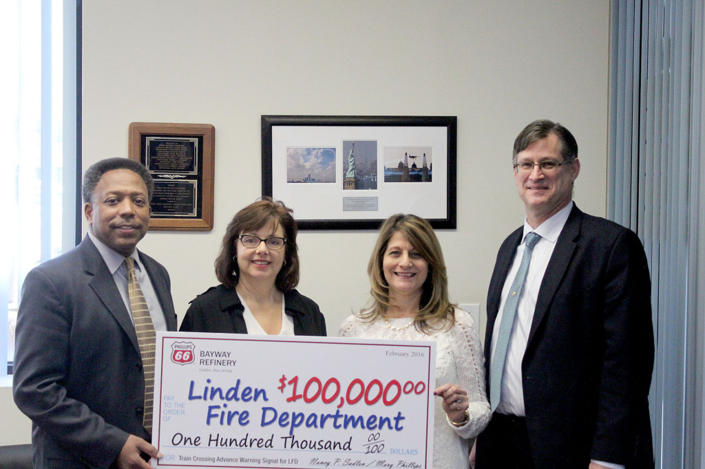 (left) Nancy Sadlon, Phillips 66 Bayway Refinery Public Affairs Manager, and Mary Phillips, the Community Relations Coordinator for Phillips 66, presented the grant to Linden Mayor Derek Armstead and Fire Chief Joseph Dooley.