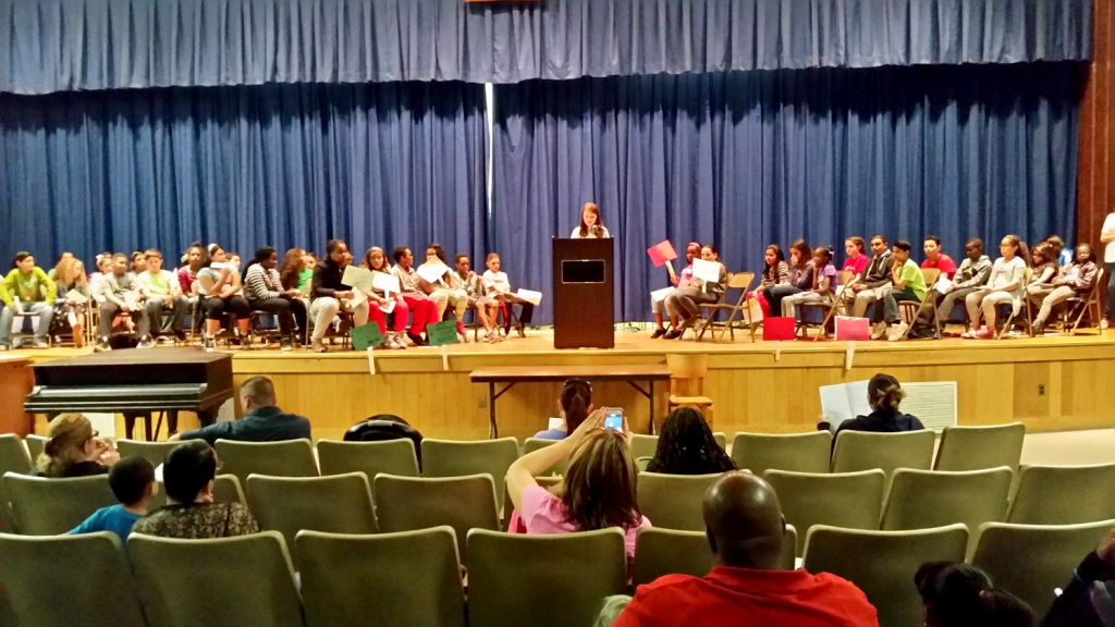 (above) At the podium is Nicole Wilk reading her essay on the benefits of drinking chocolate milk.