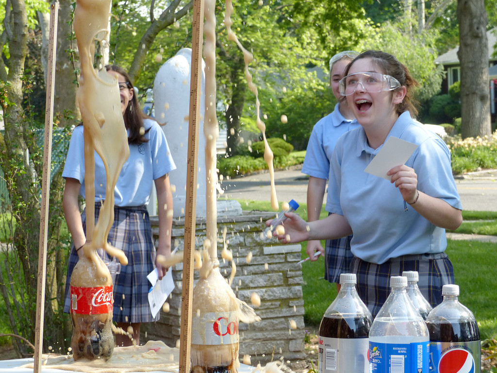 (above) To demonstrate how carbon dioxide gas in soda can cause a volcanic eruption when mixed with Mentos candy Mrs. Serrano and Mrs. Aronowitz's 8th grade class from St.Theresa School in Kenilworth did an outside experiment with just that. The students had to receive 2 out of 4 extra credit points by researching and writing a paragraph about the scientific question they would like to find answers for in the soda -Mentos explosion.