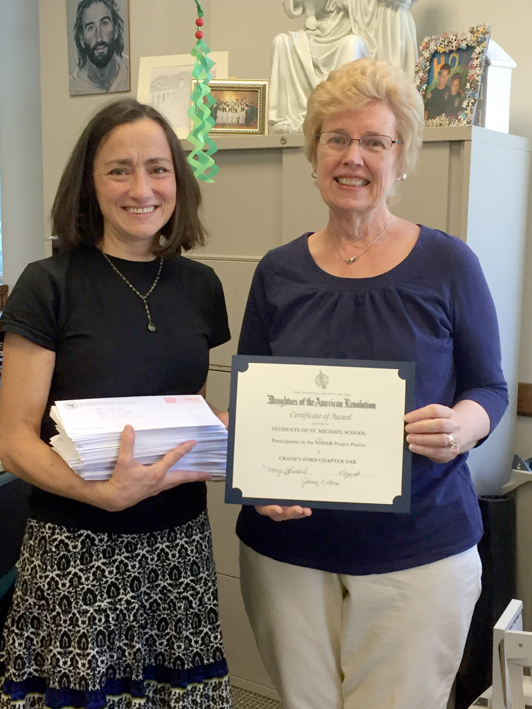 (above l-r) Mary Castle, teacher at St. Michael’s, holding some of the letters written by the students with Mary Leonard, chapter Regent.