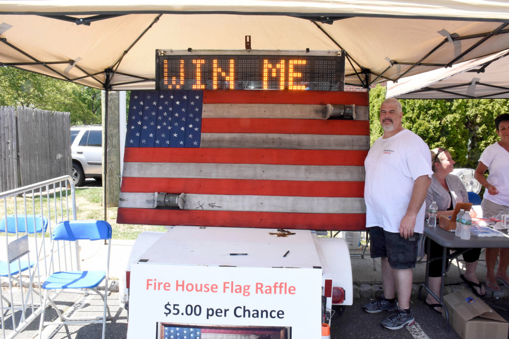 (above) Scotch Plains Police Sergeant Ernie Hernandez in front of the flag he created with old fire hoses.