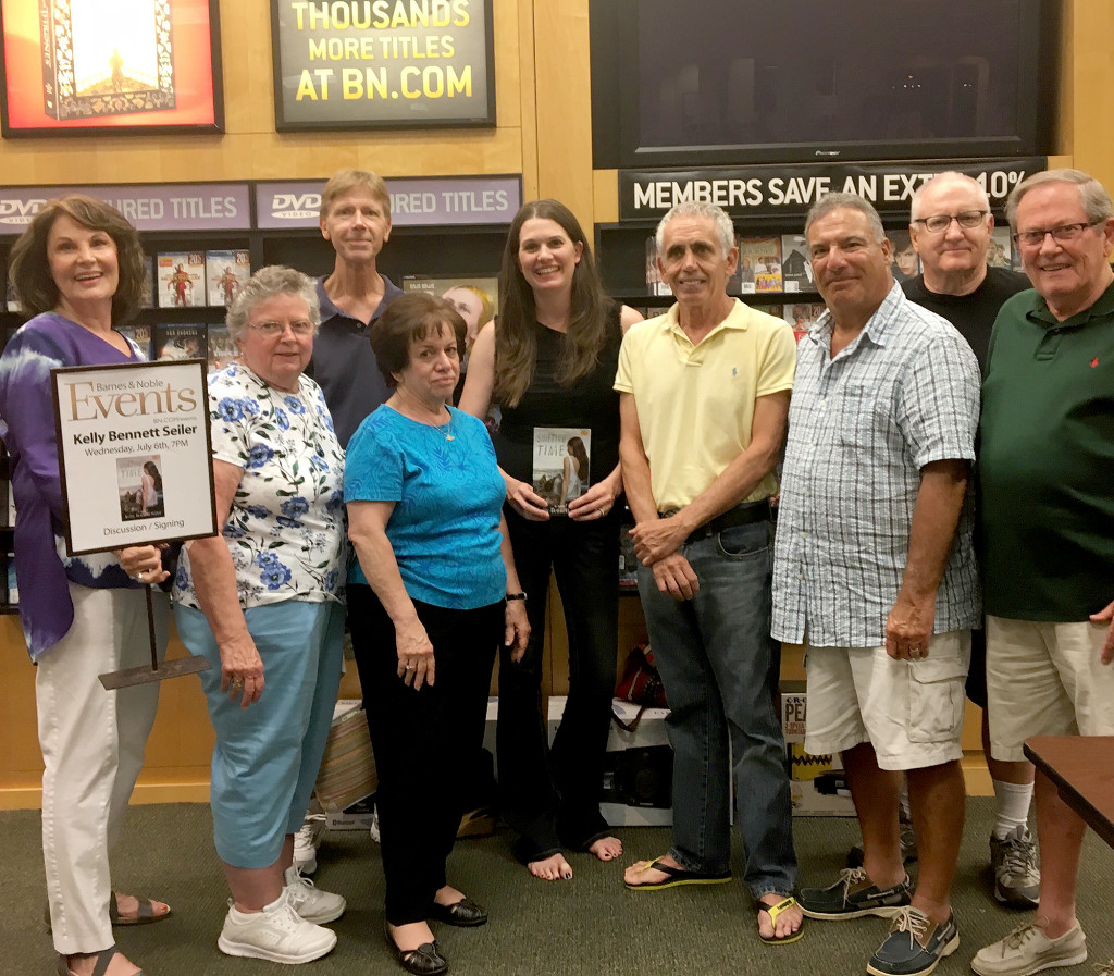 (above) Kelly Bennett Seiler, center top, is surrounded by teachers from the Clark district at her book signing of her first novel, Shifting Time, in the Clark Barnes & Noble on July 6. Friends, classmates, neighbors and faculty members came out to the event to support her.