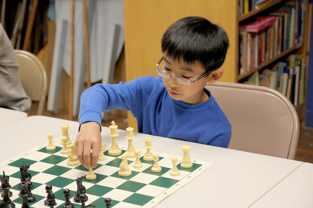 (above) Jason Ng, age 11, Watchung, makes his move at the Watchung Library Chess Club.