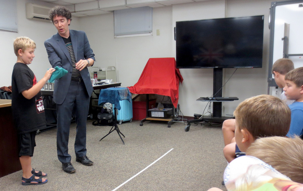 (above) Magician Francis Menotti is assisted by a young volunteer.