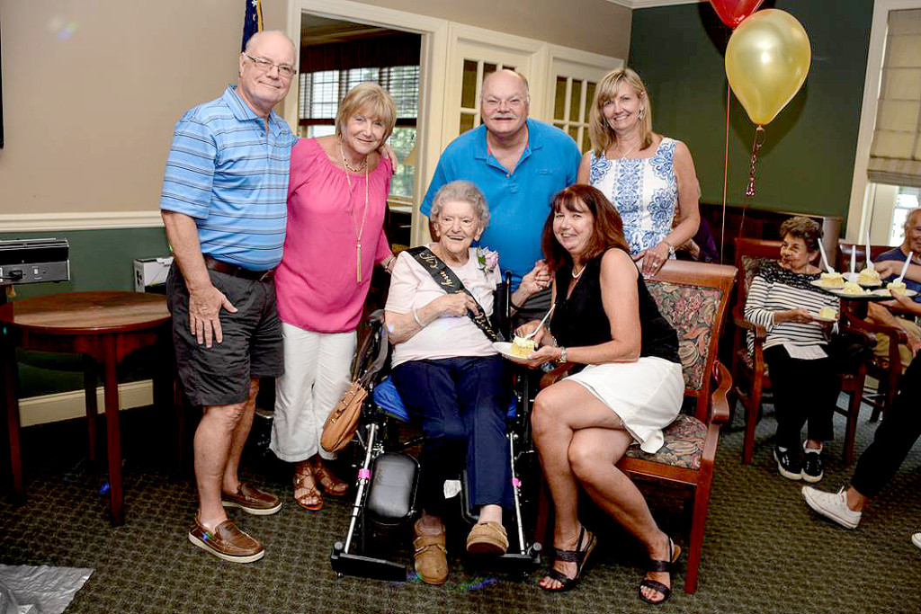 (above, center, l-r) Mrs. LaHoff makes a grand entrance into the party with family. (standing, l-r) Robert and Eva Miller, Michael Miller and Maureen Stivale, (seated, l-r) seated Mrs. LaHoff and Elaine Miller.