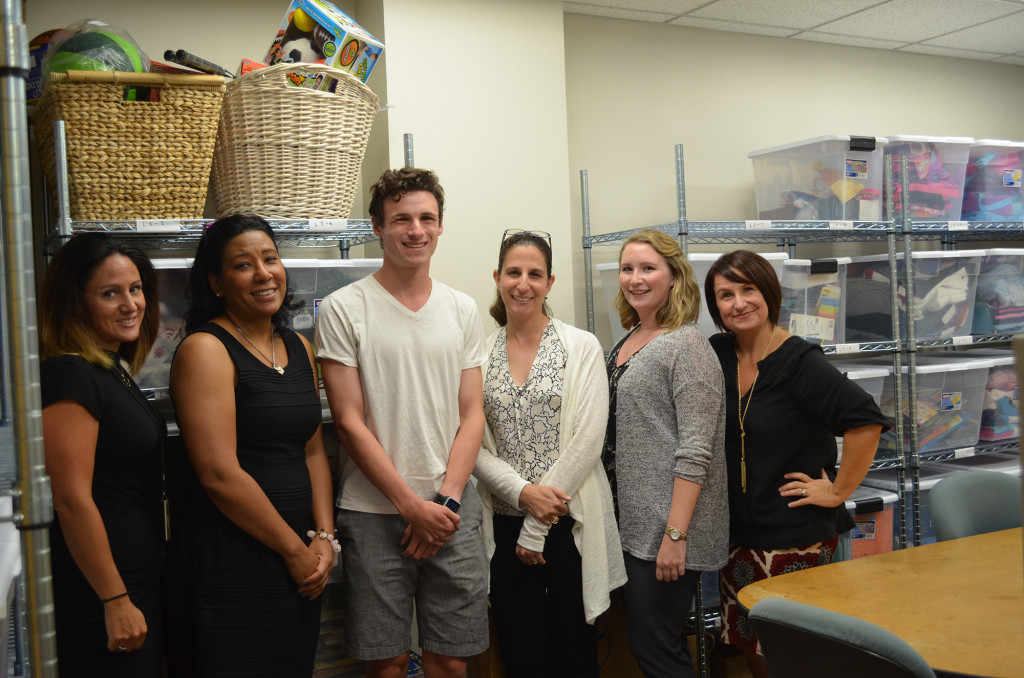 (above) Flanking Gabe are CASA staff in their new organized digs. From left, Natalie Deo, Marla Higginbotham, Lisa Poris, Kim Stocco and Gretchen Boger-O’Bryan.