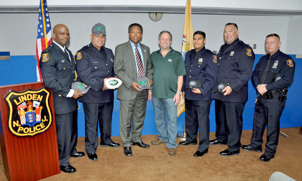 (above l-r) Chief Jonathan Parham, Officer Angel Padilla, Mayor Derek Armstead, Steven Castleton-NY Jets Law Enforcement & Military Liaison, Officer David Guzman, Officer Mark Kahana, and Officer Peter Hammer.