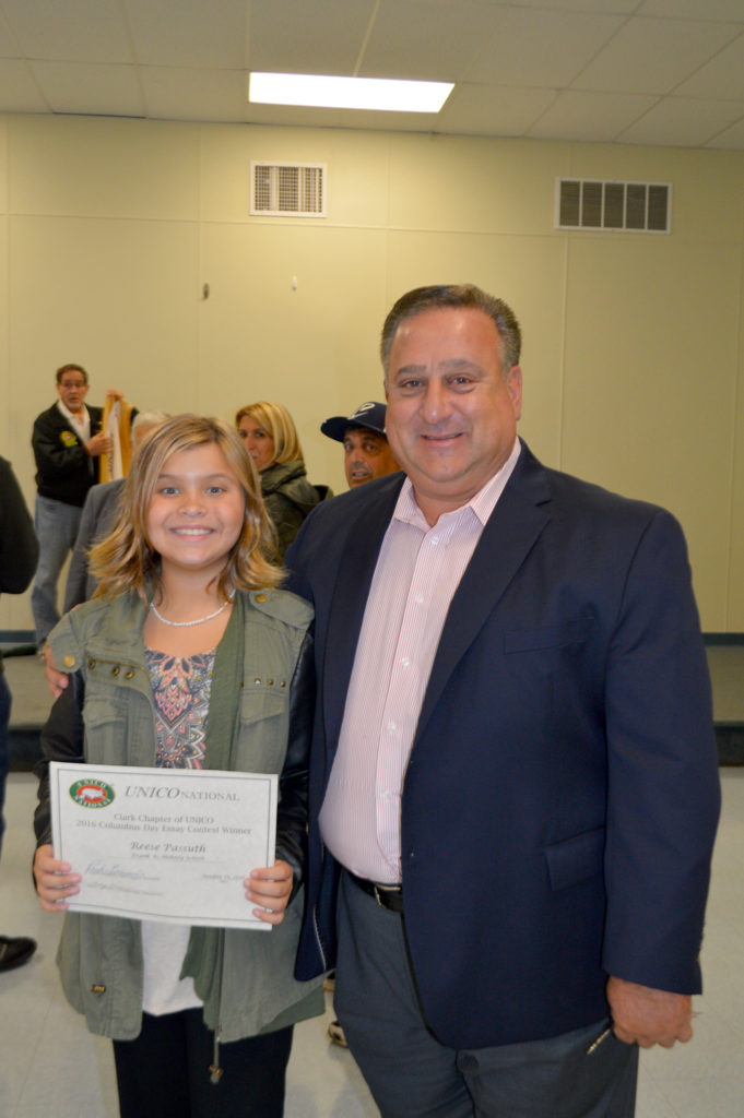 (above) Reese Passuth, fifth grader at the Frank K. Hehnly School and winner of the Columbus Day Essay contest for her school stands with Clark Mayor Sal Bonaccorso. The contest was sponsored by the Clark UNICO.
