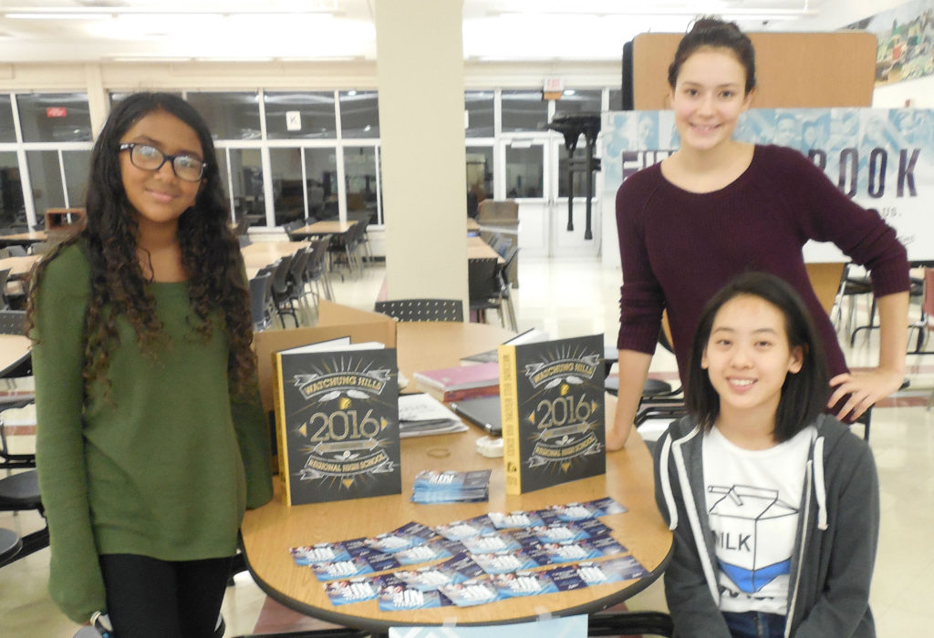 (above) Student staffers presented information the Watchung Hills Regional High School (WHRHS) Yearbook at Back to School Night, Thursday, Oct. 6. They are, standing left, Sophomore Isha Kasu of Warren Township, standing right Senior McKenzie Schuyler of Green Brook Township, and seated, Senior Emily Yan of Warren. Schuyler and Yan are editors. They said the Yearbook is a year-long project that includes interim deadlines each quarter on the way to the final product at the end of the school year.