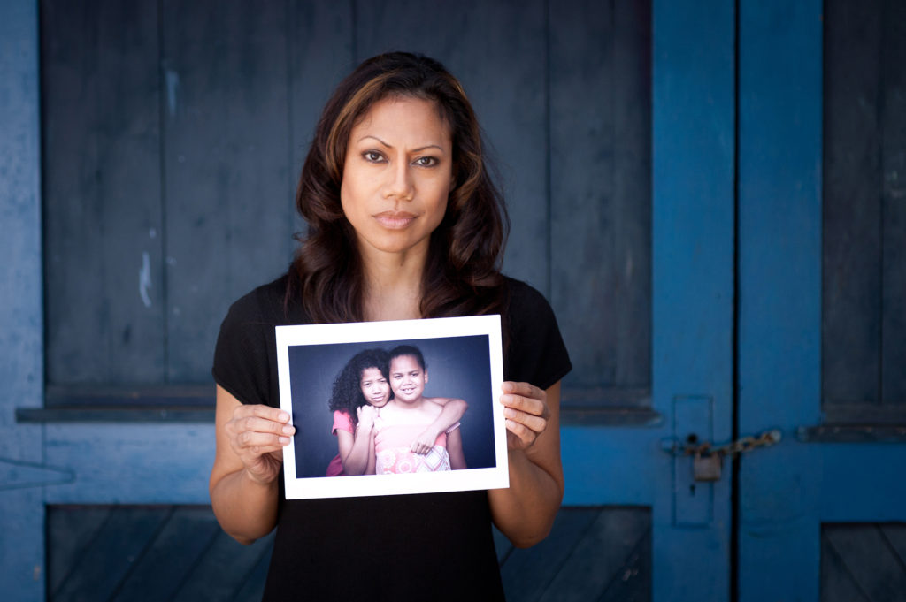 woman-holding-pic-of-2-girls